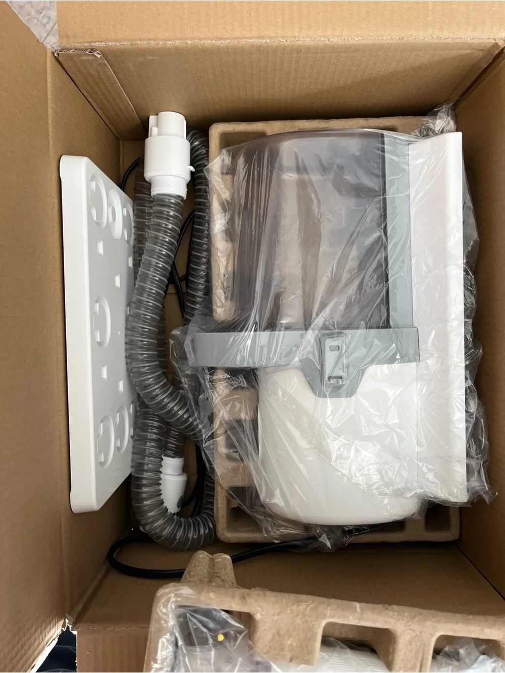 White and Gray Compact Appliance with Hose